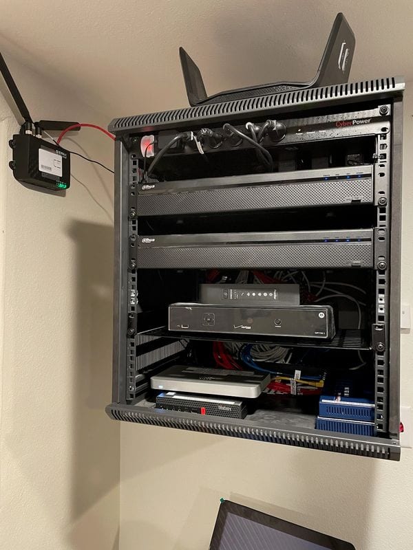 The completed wall rack: UPS, recorder and switch racked and powered, with cabling dressed to the side